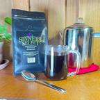 Sinners Select Coffee on counter top with coffee cup and percolator